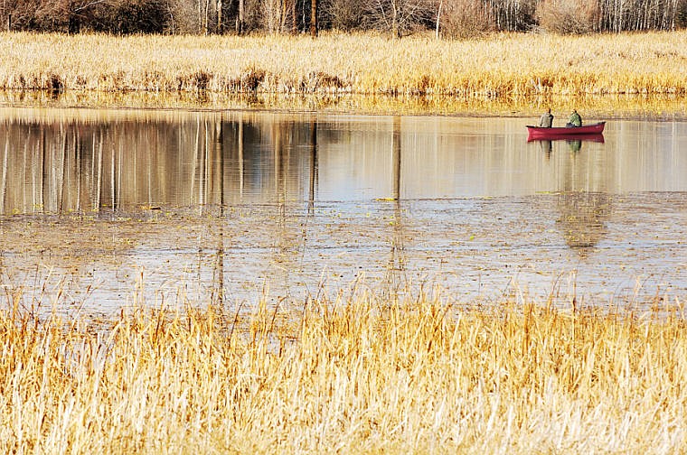 &lt;p&gt;Anglers fish from a canoe on McWenneger Slough east of Kalispell during a sunny afternoon on Wednesday.&lt;/p&gt;