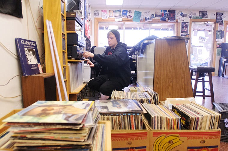 &lt;p&gt;Connor Crevier adjusts the volume of the stereo Wednesday afternoon at Old School Records. Nov. 13, 2013 in Kalispell, Montana. (Patrick Cote/Daily Inter Lake)&lt;/p&gt;