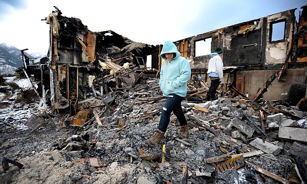 &lt;p&gt;Darien Matthews makes her way through the remains of the family
home Friday afternoon east of Kalispell. The Matthews&#146; house was
destroyed by a fire Wednesday. In the background Kaden Matthews,
10, picks his way through the rubble.&lt;/p&gt;