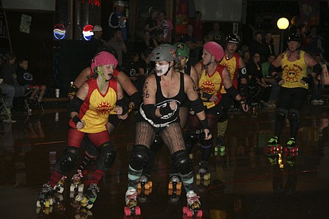 &lt;p&gt;Kristie Blair, center, captain of the Venomous Vixens of the Snake Pit Derby Dames roller derby league, battles the Tri Cities High Desert Darlins during Sunday night's bout at the Skate Plaza in Coeur d'Alene. Forty skaters participate in the Snake Pit, and all-female league that continues to grow.&lt;/p&gt;