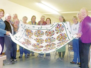 &lt;p&gt;The Yaak Women&Otilde;s Club has recently created a quilt which they have traded to Fred and Carol Seton for a custom built wood stove for the historic Yaak Community Hall.&Ecirc; The quilt (which is pictured) is a beautiful and colorful, Circle Quilt design, and hand-quilted by the members of the Yaak Women&Otilde;s Club.&Ecirc; (Carol Seton is in the far right of the photo receiving the quilt). The Yaak Women&Otilde;s Club is dedicated to promote the welfare and integrity of the Yaak community as a whole, working together to create a financial base through quilting, crafting and volunteerism to support the Yaak Community Hall and lend support to other worthwhile projects.&Ecirc; The Yaak Community Hall was in need of a new wood stove to replace the aging barrel stove, which was quite inefficient.&Ecirc; So in this need, the offer was made to Fred and Carol Seton, of the Yaak, to trade a quilt for a wood stove.&Ecirc; The bartering trade has now been completed and the wood stove has been installed.&Ecirc; Thanks is given to all who helped in achieving and meeting this goal.&lt;/p&gt;