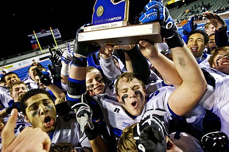 &lt;p&gt;Matt Howard hoists the 5A State Football Championship trophy above his head as he celebrates with his teammates after defeating Eagle High 49-28 and maintaining their perfect record of 12-0.&lt;/p&gt;