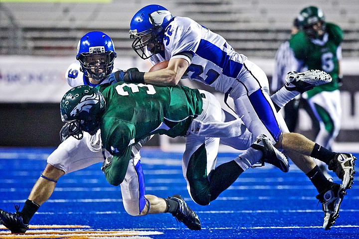 &lt;p&gt;JEROME A. POLLOS/Press Coeur d'Alene High's J.J. Johnson puts a hit on D.J. Dean from Eagle High as another Viking defender, Reece Mahaffy, close in to assist in the stop.&lt;/p&gt;