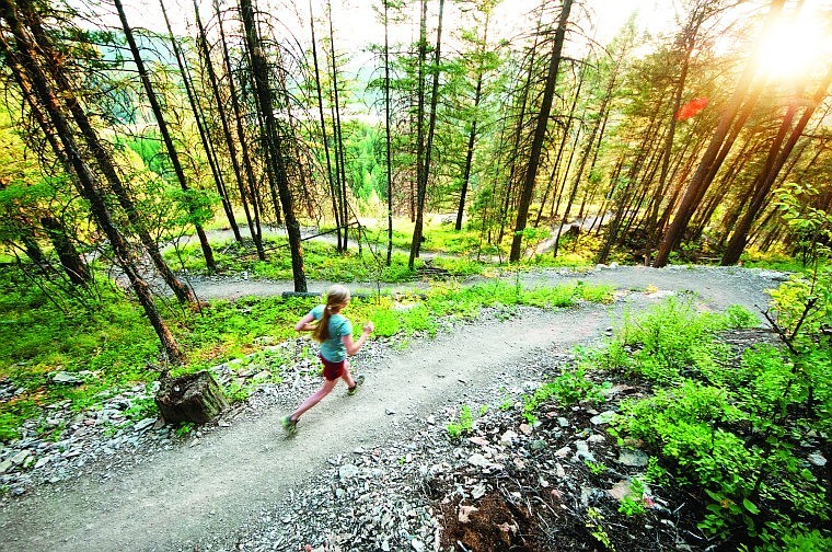 A runner traverses the Lion Mountain section of the Whitefish Trail.