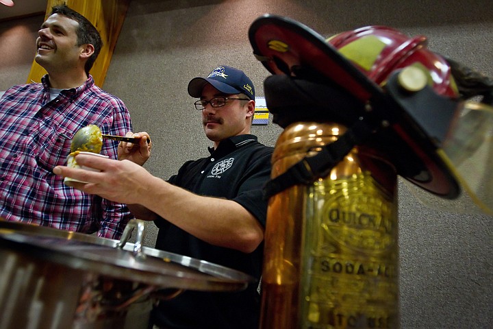 &lt;p&gt;Coeur d'Alene firefighters Battle Chief John Morrison, left, and Capt. Luke Pichette serve samples of Morrison's Guinness Pumpkin Bisque soup with a spiced creme fraiche.&lt;/p&gt;