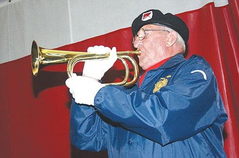 Nick Ianniello/Mineral Independent VFW Post 6238 Bugler Bernie Walsh plays taps during a Veteran's Day ceremony at Superior Elementary Tuesday afternoon. Students gathered in the school's gym after classes to pay their respects to veterans.
