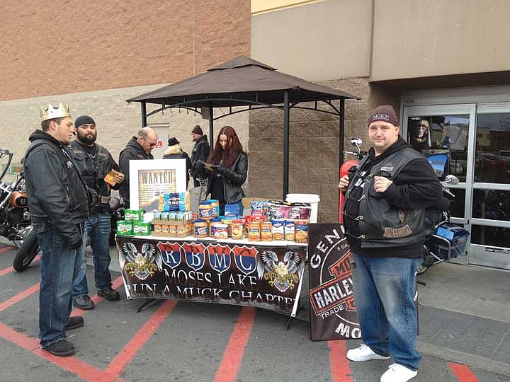 Members of the RoadBrother MC Moses Lake chapter help out during the food drive held at Walmart Sunday.