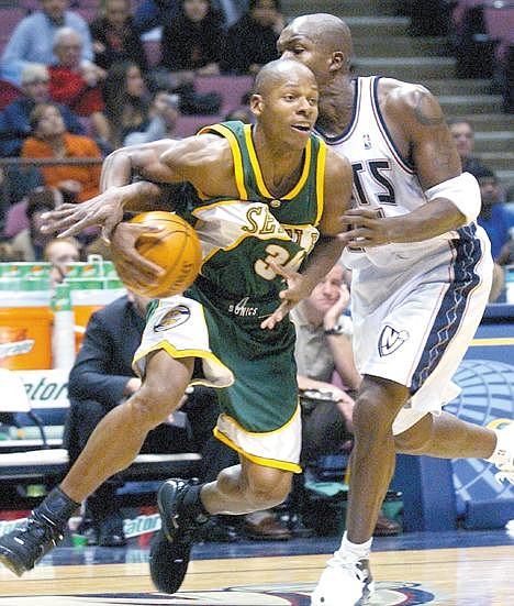 Seattle SuperSonics' Ray Allen, left, is fouled by New Jersey Nets' Eric Williams as he drives to the basket during the fourth quarter Wednesday night, Nov. 17, 2004 in East Rutherford, N.J. The SuperSonics beat the Nets 79-68. (AP Photo/Bill Kostroun)
