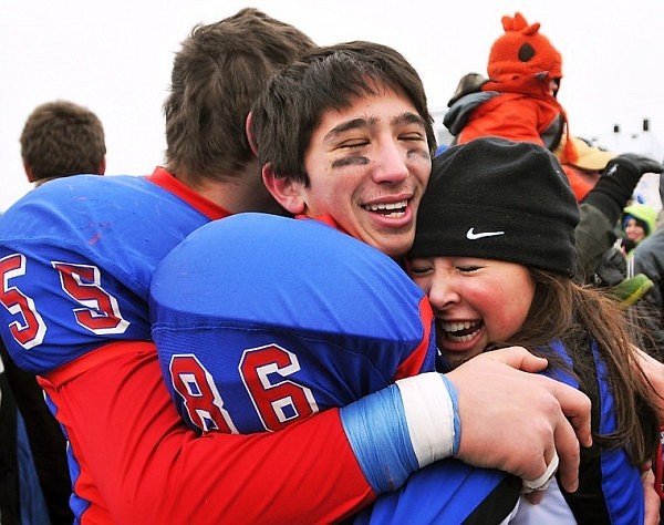 Bigfork Cheerleader Keiko Sagami, right, gives a hug to Kenji Sagami (86) and Matt Edwards (55) as the team celebrates their victory.