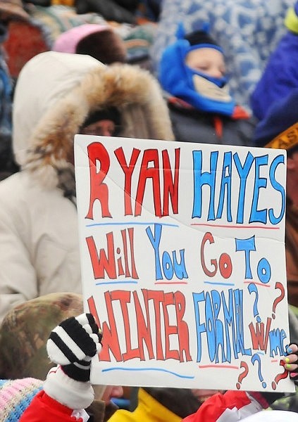 A student holds up a sign, hoping to get the attention of a Bigfork player.