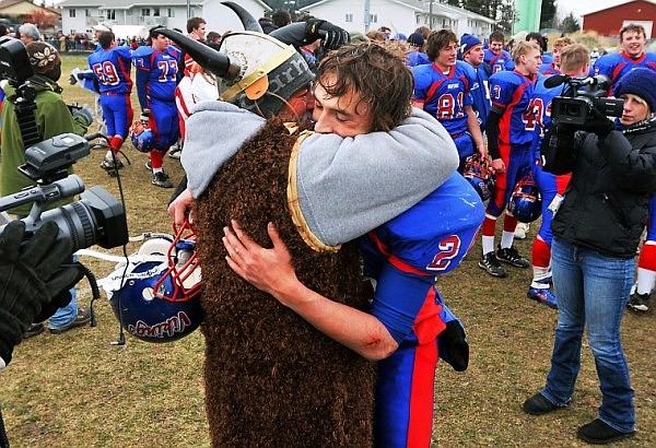 Bigfork's Travis Knoll gets a hug from his dad, Bill Knoll, as the team celebrates its first ever State Football Championship on Saturday in Bigfork. The Vikings won the game on a 7-yard touchdown pass from Christian Ker to Travis Knoll with eight seconds remaining in the game.