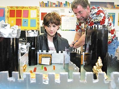 Seventh-grade teacher Rick Funk asks 12-year-old Taylor Baer to point out required components of a castle she built as part of a project on fantasy literature at Kila School. Jennifer DeMonte/Daily Inter Lake