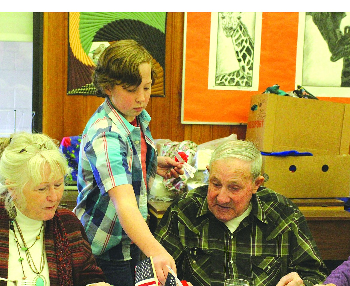 &lt;p&gt;Wiley Scribner hands out poppy flower pins to veterans during the honorary lunch at Plains School last week.&lt;/p&gt;