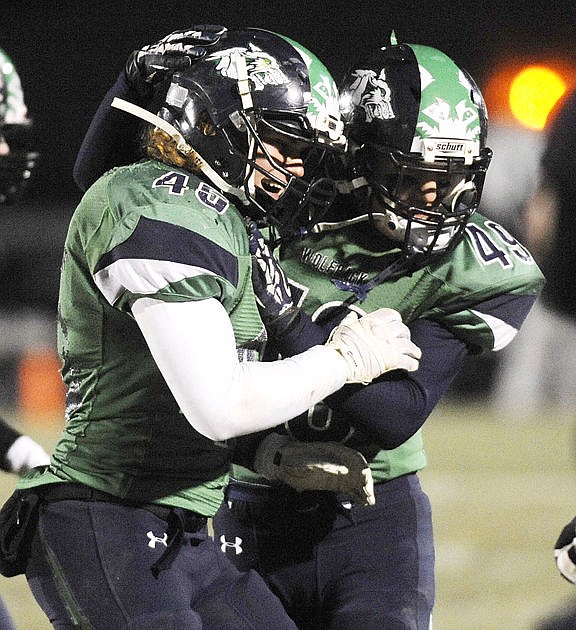 <p>Glacier linebacker Josh Hill celebrates with Arik Lybeck during the Wolfpack's semifinal win against Big Sky last week. (Aaric Bryan/Daily Inter Lake)</p>