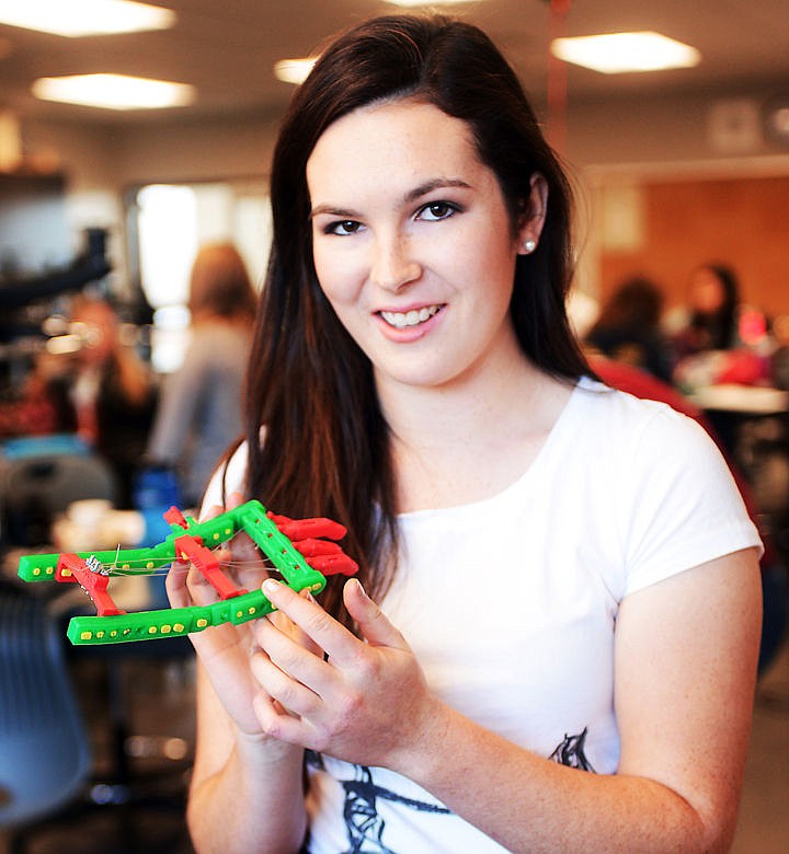 <p>Donaldson displays a prosthetic hand created by a 3-D printer at Whitefish High School.</p>