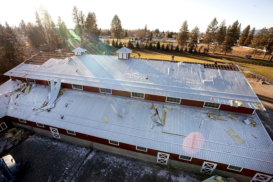 &lt;p&gt;Ten workers from Edward Smith Construction repair the corrugated steel roof of John and Joy Richard's horse barn in Hayden on Friday. The roof was badly damaged in Tuesday's wind storm, and the majority of it has to be completely replaced.&lt;/p&gt;