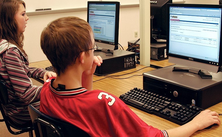 Whitefish Middle School students Danielle Morris and Joey Winn use the Web-based My Access writing program Nov. 12 at the school&#146;s computer lab.