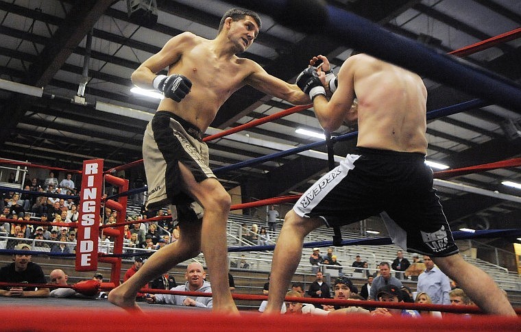 Kalispell's Zach Dickson throws a punch at Butte's Kahl Clark during Kalispell Kombat at Majestic Valley Arena Friday evening.