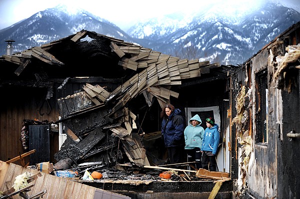 &lt;p&gt;From left, single mother Hayley Matthews and her children,
Darien, 12, and Kaden, 10, survey the damage to their home Friday
afternoon.&lt;/p&gt;