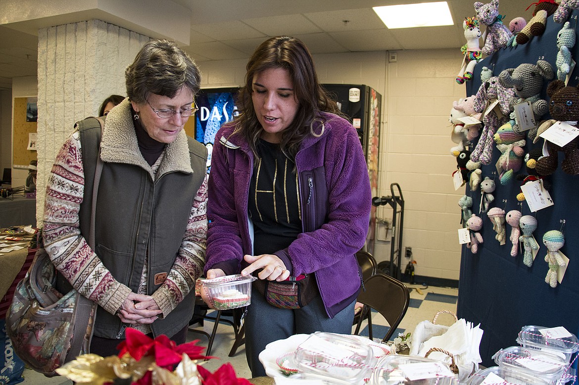 &lt;p&gt;BETHANY BLITZ/Press&lt;/p&gt;&lt;p&gt;Marianella Baker helps a customer, Diane Tapia, choose which confection to buy at her stand at the Coeur d&#146;Alene High School Holiday Gift Faire. Baker sold baked goods and trinkets from Peru while her mother-in -law sold crocheted animals.&lt;/p&gt;