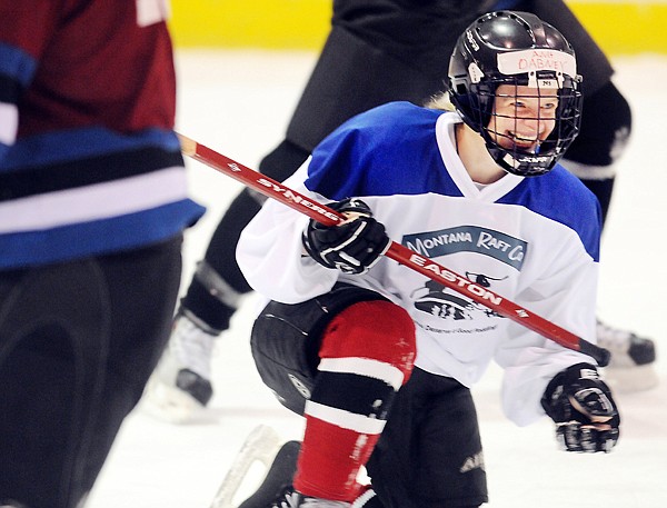 Dabney Langellier (5) comes up smiling after a spill on the ice during the Tuesday night game at the Stumptown Ice Den.