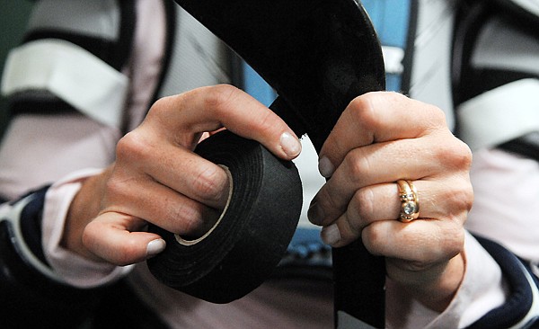 Kelly Davidson (80) re-tapes her stick after the game on Tuesday night in Whitefish.