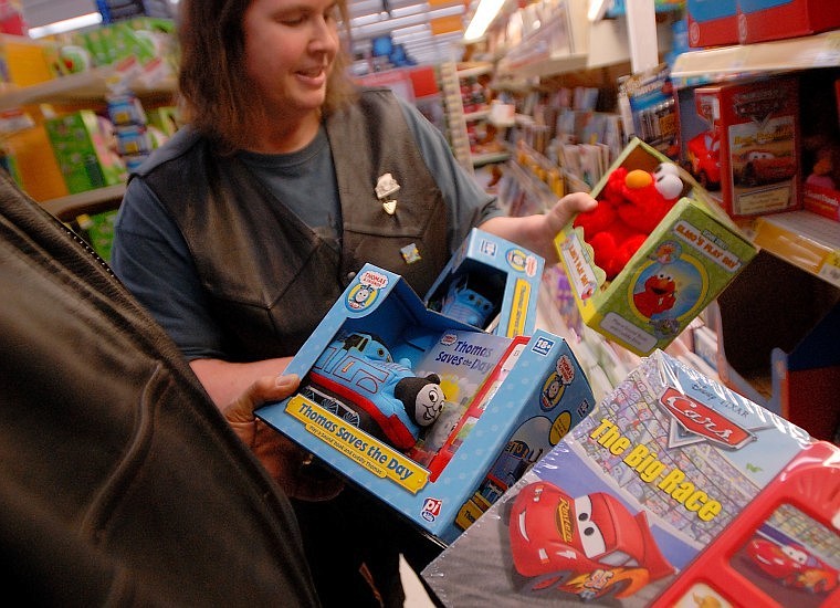 Sharon Swift tries to decide which toy is the best value as she shops with David Gray on Thursday.