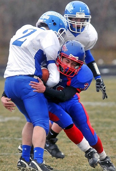 Bigfork's Alex Ruiz wraps his arms around Fairfield's Troy McInerney (2).