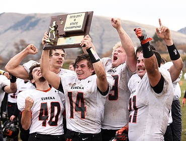 <p>The Eureka Lions hold up the plaque for their first state title after defeating Missoula Loyola 31-28 on a Hail Mary as time expired in the Class B Championship at Loyola on Saturday. (Aaric Bryan/Daily Inter Lake)</p>