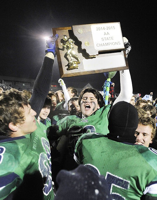 <p>Truman Pisk (59) and Andrew Harris hold up the trophy during the celebration. (Aaric Bryan/Daily Inter Lake)</p>