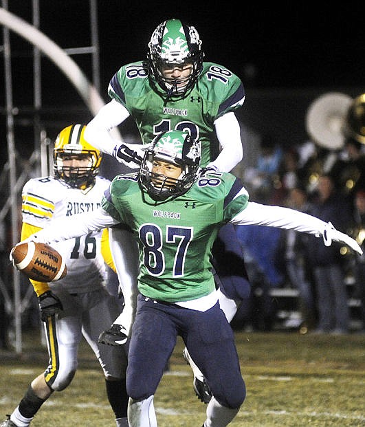<p>Glacier's Sam McCamley jumps on Jacob Janke's back after Janke scored a touchdown in the second quarter. (Aaric Bryan/Daily Inter Lake)</p>