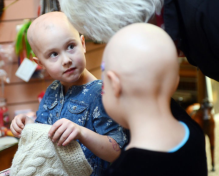 &lt;p&gt;Kiersten Koelzer looks up at Joyce Sterkel, Lilia's mother, as she removes her hat to have her face painted on Friday afternoon, Nov. 14, at Picture Me Makeover Studios in Kalispell.&#160;&lt;/p&gt;