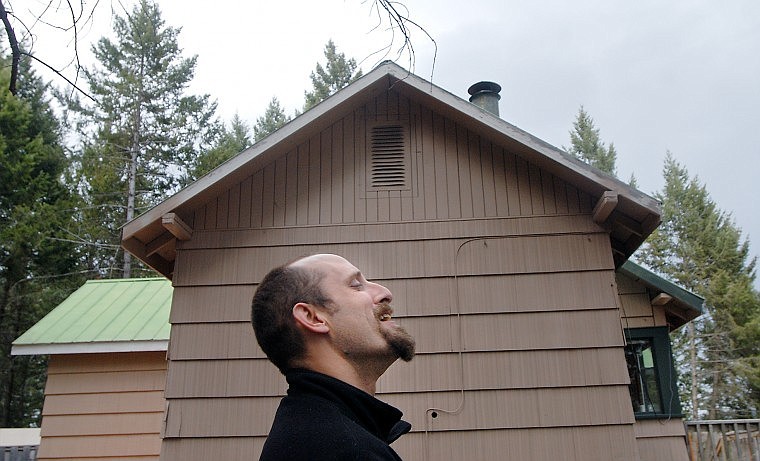 Kyle Lathrop laughs while talking with Perry Topp (not pictured) outside a Columbia Falls house he has been working on for just over a month. The four-bedroom, three-bathroom house is for sale for $165,000.