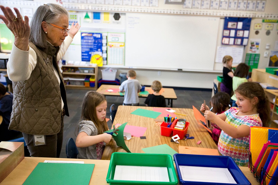 &lt;p&gt;Winton Elementary first-grade teacher Ann Porter-Brown works with students Savannah Hauser, second from left, and Emma Duran as they create turkeys out of paper on Monday at Winton.&lt;/p&gt;