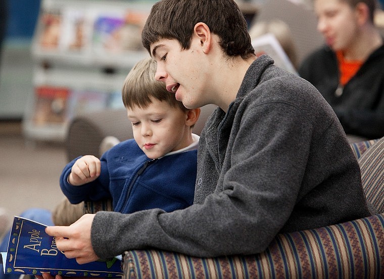 Flathead senior Dominic Eickert reads with St. Matthew&#146;s kindergartener Drew Mizner in the FHS library on Nov. 11.