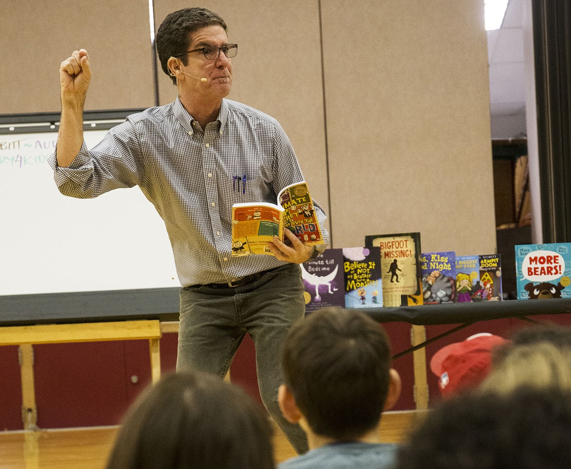 &lt;p&gt;Children's author Kenn Nesbitt reads &quot;The Ultimate Top Secret Guide to Taking Over the World,&quot; to students at Fernan Elementary School on Monday.&lt;/p&gt;