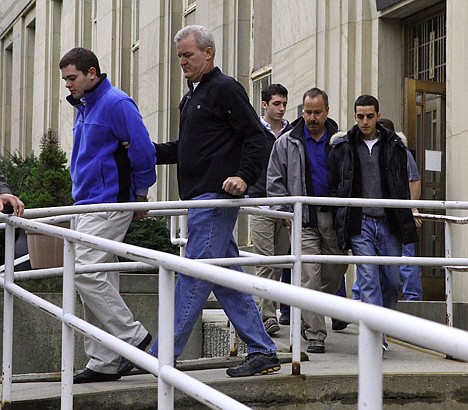 &lt;p&gt;AP Photo/Newsday, Howard Schnapp Joshua Chefec, left, Adam Justin, background center, and George Trane, right, are escorted from of the Nassau District Attorney's office, in Mineola, N.Y., on Tuesday. Thirteen more current and former high school students from Great Neck, on New York's Long Island, were charged Tuesday in a widening college entrance exam cheating scandal, bringing the total to 20.&lt;/p&gt;