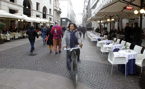 &lt;p&gt;A woman rides past empty tables outside a cafeteria in downtown Milan, Italy Tuesday, Nov. 22, 2011. More than 90 percent of Italians consider cutting the country's huge public debt a top priority over the coming years, but few are willing to make the sacrifices necessary to do so, according to a new AP-GfK poll released Tuesday. The survey was conducted Nov. 16-20, during the first days of economist Mario Monti's new government, brought to power after international financial markets pummeled Italy for failing to rein in its euro 1.9 trillion in debt, a euro zone high, coming in at 120 percent of GDP. (AP Photo/Luca Bruno)&lt;/p&gt;