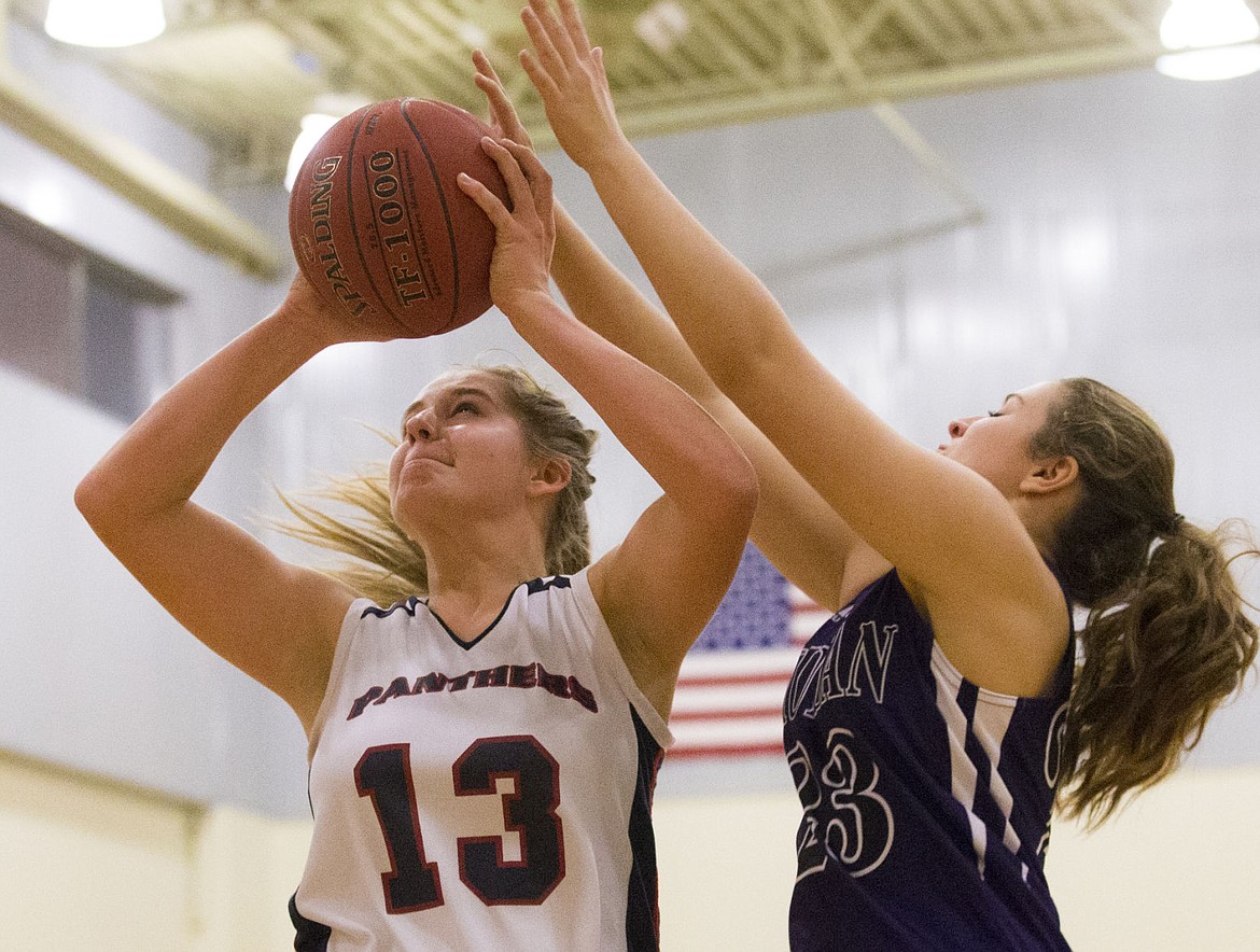 &lt;p&gt;LOREN BENOIT/Press Coeur d'Alene Charter's Sandy Faulkner drives to the basket as Mullan defender Taylor Davis tries to block the shot during Tuesday night's game at Holy Family Catholic School. Charter beat the Tigers 44-11.&lt;/p&gt;