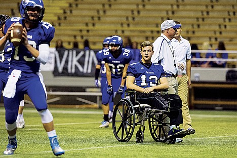 &lt;p&gt;Gunnar Lee watches from his wheelchair as Austin Lee warms up before the state 5A football championship Friday in Moscow.&lt;/p&gt;