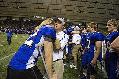 &lt;p&gt;Head coach for the Coeur d&#146;Alene High School football team Shawn Amos hugs his son Gunnar, who was injured earlier in the playoffs, after the Vikings won the Idaho State 5A championship against Highland High School Friday at the Kibbee Dome in Moscow.&lt;/p&gt;