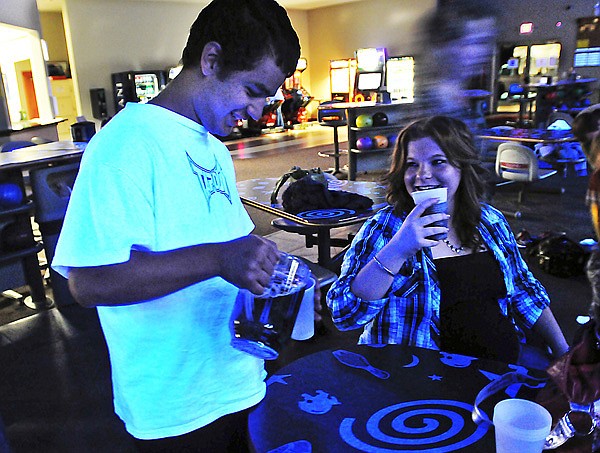 Chris pours himself a cup of root beer while out for a night of glow-in-the-dark bowling at Pick's Bowling Center with his youth group from Valley Community Church of God.