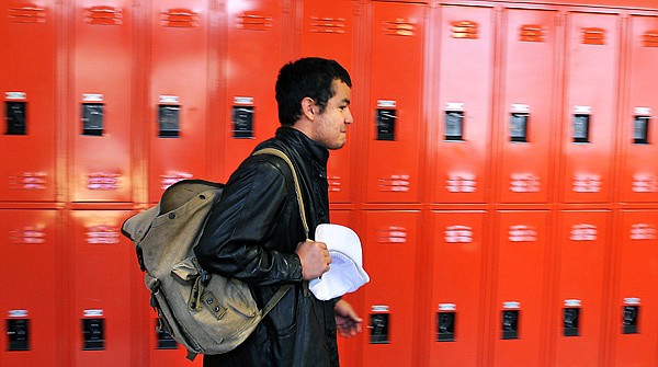 Chris walks through the hallway at Bridge Academy toward class.