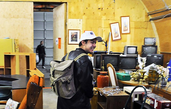 Skaggs shares a laugh with a coworker as he heads out for the morning for school after working at Hope Thrift. Skaggs, 18, moved into a Ray of Hope shelter about four months ago and until recently, when he got a job at Target, worked at the organization's thrift store in the mornings and afternoons between his time at school.