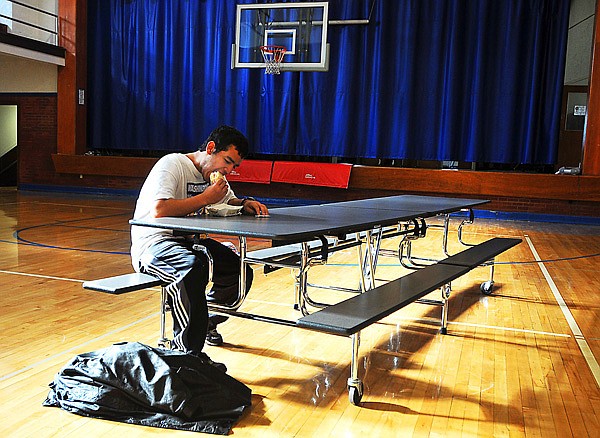 Chris Skaggs has a ham-and-cheese sandwich accompanied by a chocolate chip cookie for lunch before starting his classes for the day at Bridge Academy. Skaggs, 18, moved into A Ray of Hope shelter about four months ago. With help from his new friends at the shelter, Chris returned to school this past fall, needing to only complete one more credit to finish his high school education.