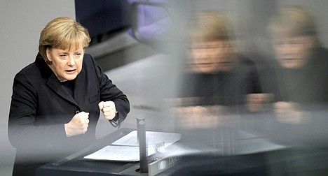 &lt;p&gt;German Chancellor Angela Merkel gestures during her speech of the budget debate at the German Federal Parliament, Bundestag, in Berlin, Germany, Wednesday, Nov. 23, 2011. Germany's chancellor says Greece can only receive its next batch of bailout loans if all parties supporting the new government in Athens commit in writing to the conditions attached to a separate aid package. (AP Photo/Michael Sohn)&lt;/p&gt;