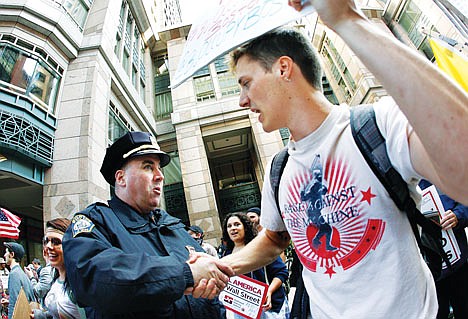 &lt;p&gt;AP Photo/Elise Amendola, file In this Oct. 5 photo, an Occupy Boston protester shakes hands with a police officer after a rally in Boston's financial district. In the first two months of the nationwide Occupy Wall Street protests the movement has cost local taxpayers at least $13 million in police overtime and other municipal services, according to a survey conducted by The Associated Press.&lt;/p&gt;