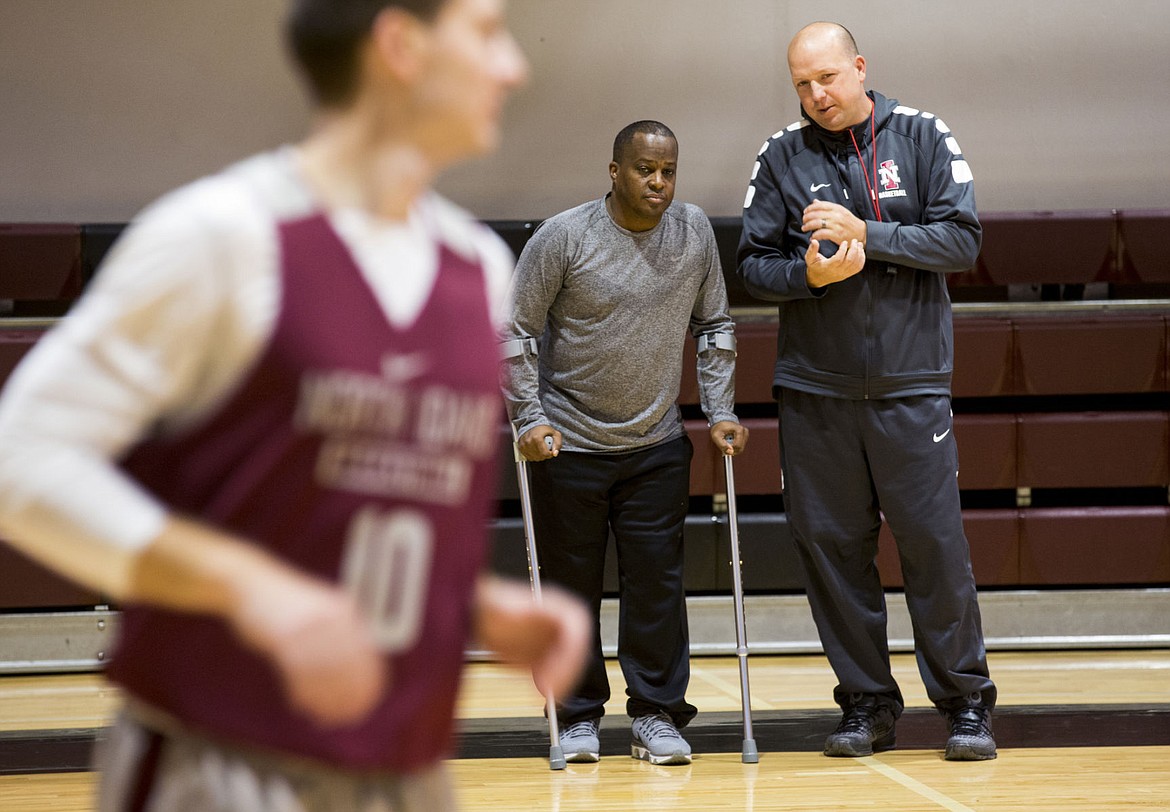 &lt;p&gt;North Idaho College basketball head coach Corey Symons, right, chats with assistant coach George Swanson at practice Tuesday afternoon.&lt;/p&gt;