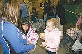 Kindergarten, sixth grade students help bag food