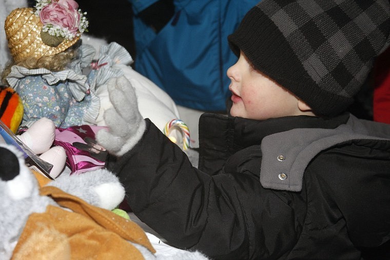 Zayden Allen peruses the collection of toys after a visit with Santa at the Annual Fairground Christmas Lighting on last Sunday.